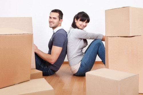Packed household boxes and furniture being prepared for local relocation